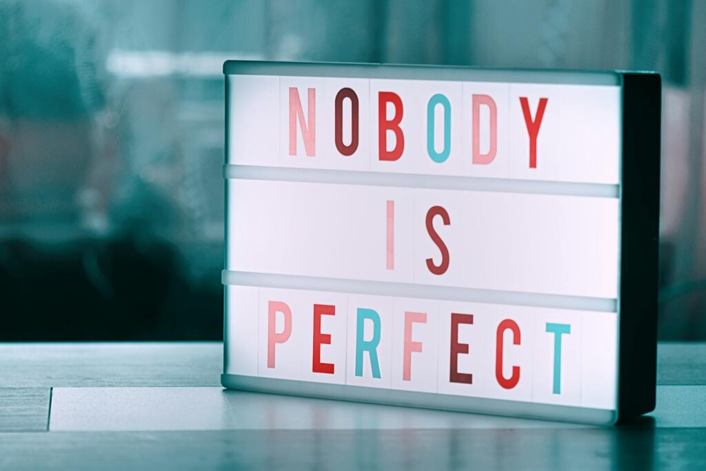Close-up of a light box displaying 'Nobody is Perfect' inspiring self-acceptance.